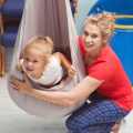 Child using sensory swing at WonderKids